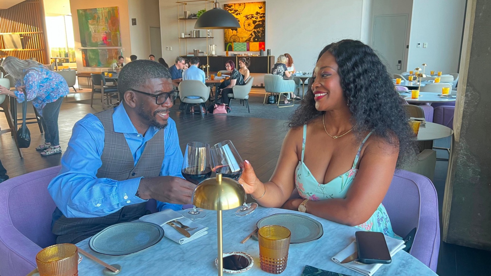 Edmund and Sylvia toasting with red wine at dinner