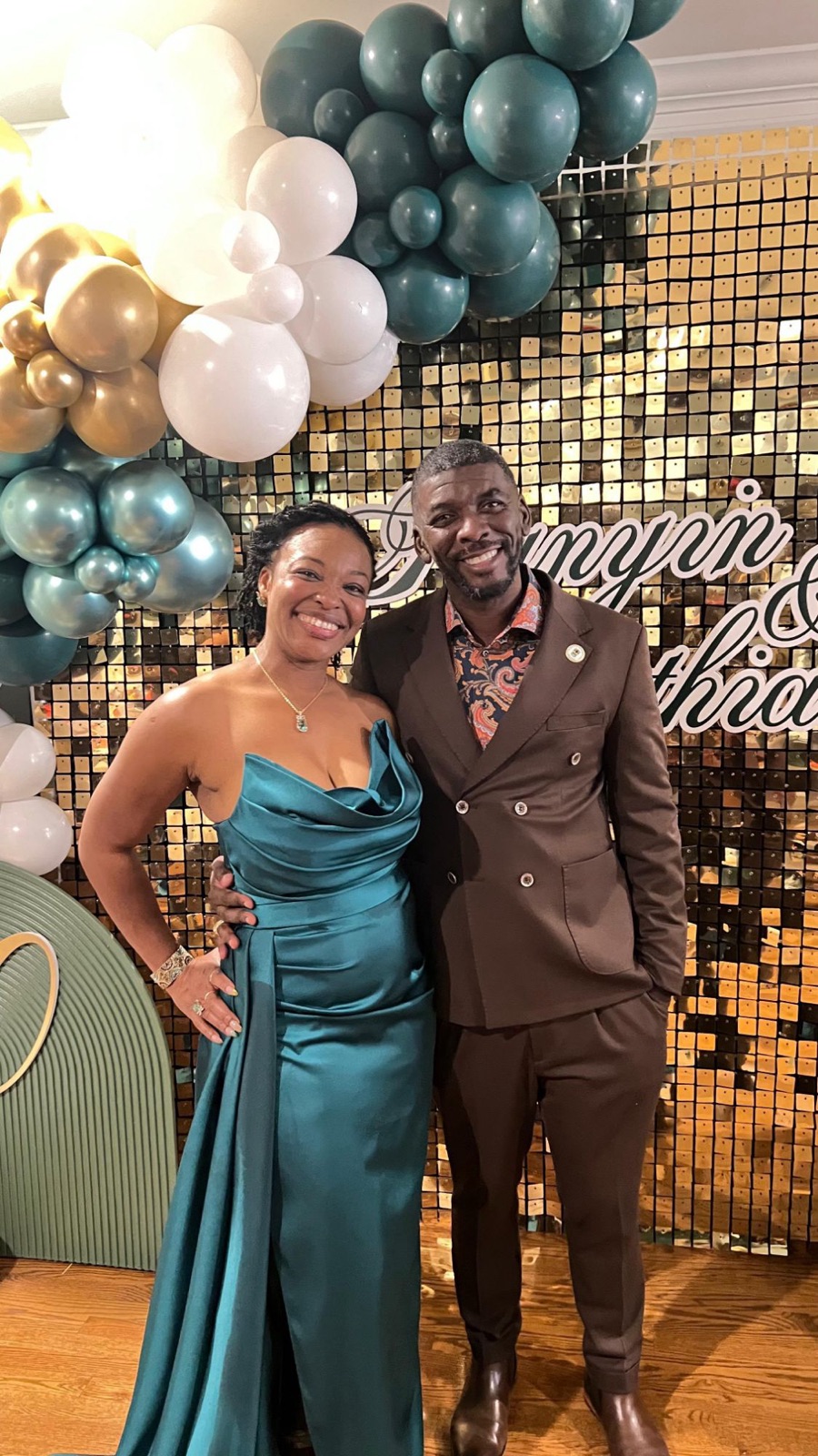 Sylvia in a teal gown and Edmund in a brown suit